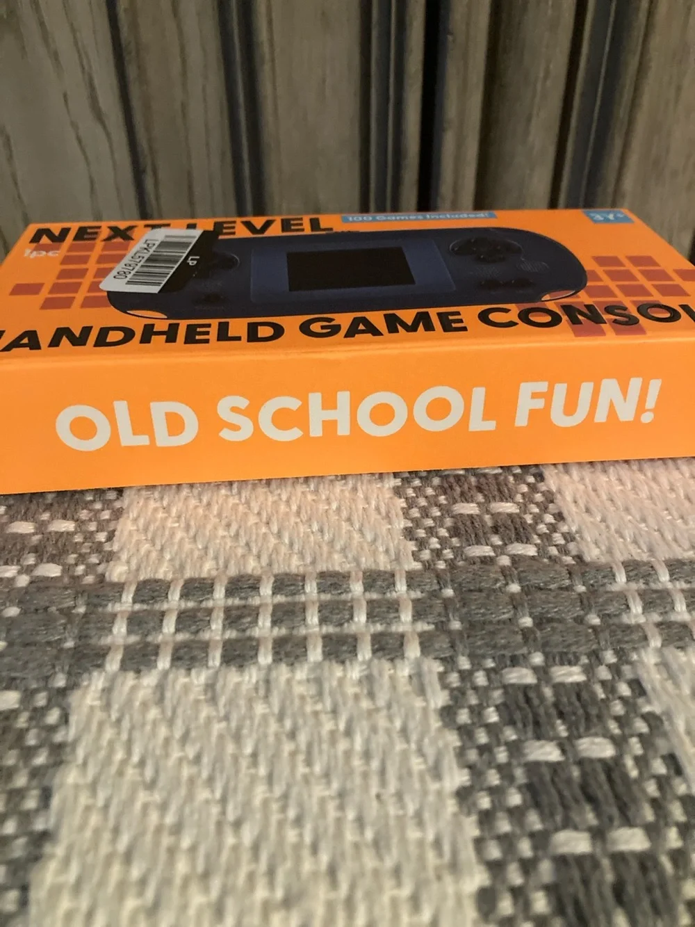 Next Level Apparel Handheld Game Console - Orange Box, Blue Device